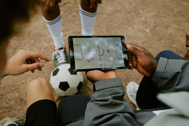 istock Boys Discussing Soccer Tactics Using Digital Tablet Outdoors 2230206908