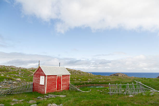 istock Cape Bonavista red shed with rustic fence under bright blue sky 2230209192