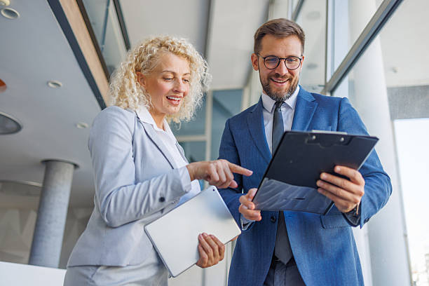 istock Businesswoman pointing at documents held by businessman in office 2230212817