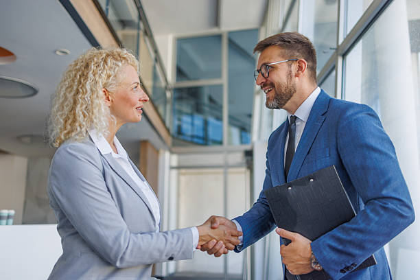 istock Businesspeople shaking hands in modern office building 2230212857
