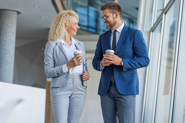 istock Businesspeople walking and talking during coffee break 2230212865