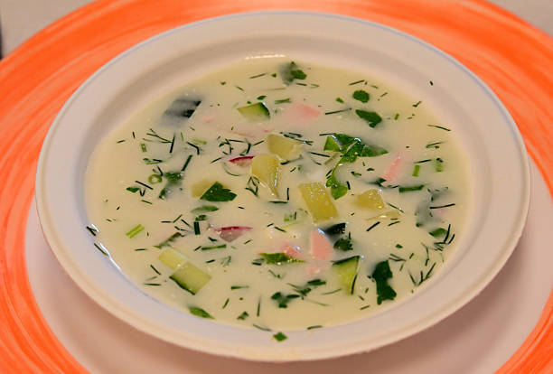 Okroshka with radishes, dill and egg served on an orange blanket