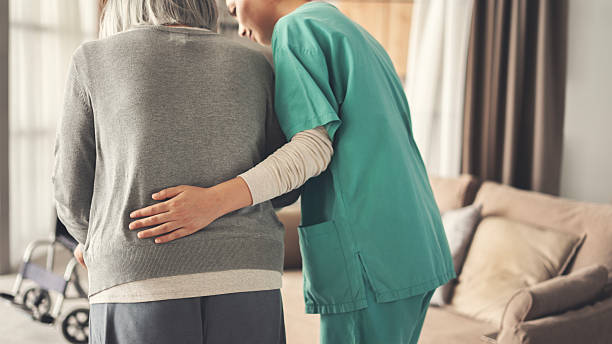 istock The nurse helps the elderly patient to walk 2230219954