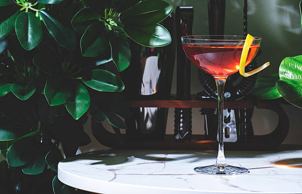 istock Killer Queen alcoholic cocktail drink with gin, aperitif, bitters, liqueur and lemon twist with bar tools 2230222963