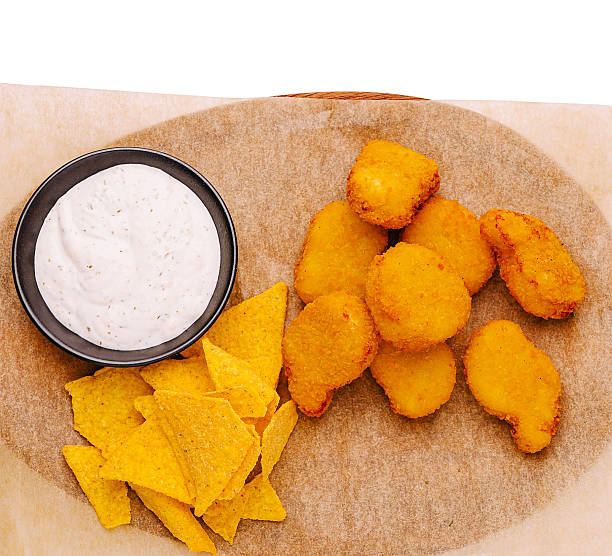 Crispy fried snacks served with creamy dip on a wooden platter