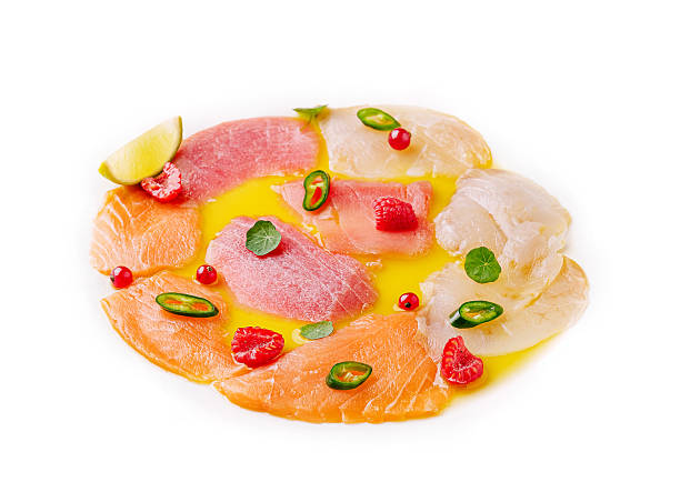Fresh seafood platter featuring assorted fish with garnishes and sauce