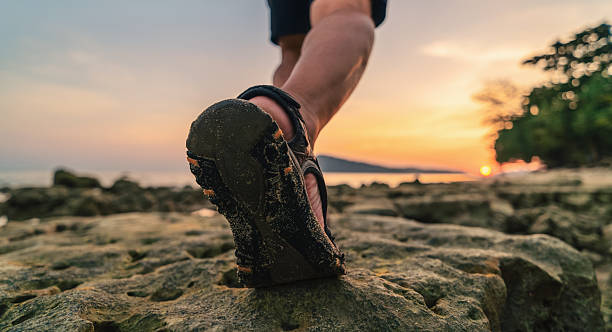 istock mans walk on the beach, closeup 2230224371