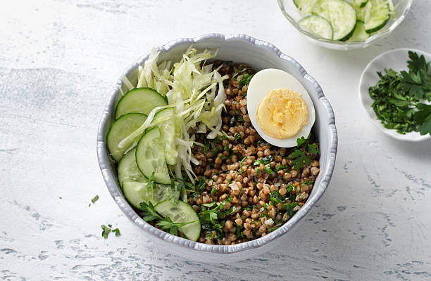 istock Nutritious buckwheat bowl with fresh cucumber, cabbage, and egg, copy space 2230227419