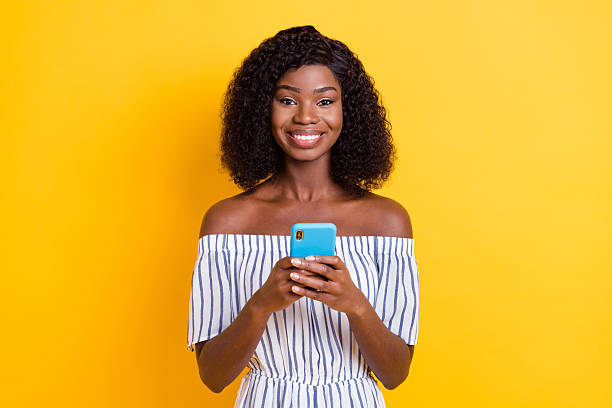 istock Portrait of attractive cheerful girl using device gadget browsing web multimedia isolated over bright yellow color background 2230227982