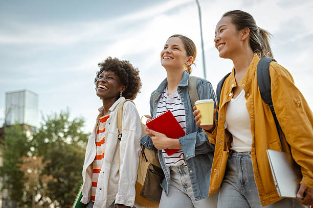 istock Three female students walking outdoors enjoying conversation and bonding on a sunny day 2230228303