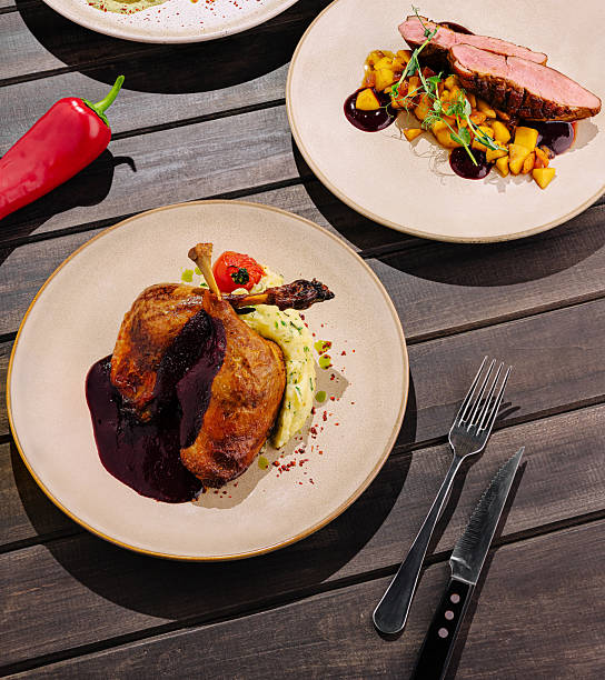 istock Delicious gourmet dish featuring duck and mashed potatoes on a wooden table 2230229064