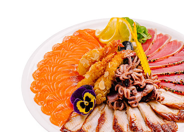 Assorted sashimi platter with fish, veggies, and garnishes