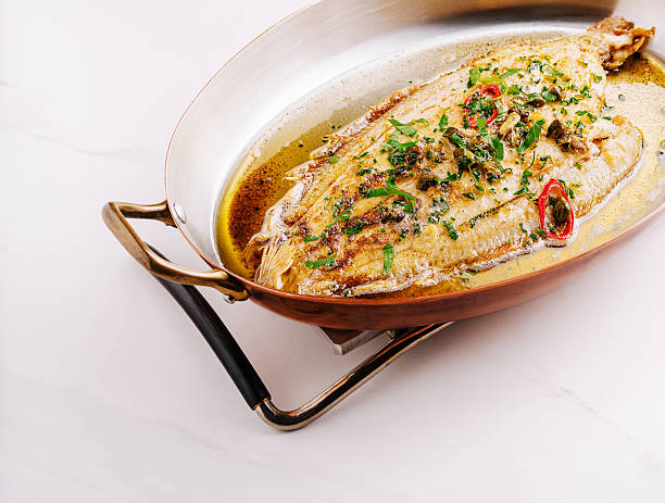 istock Deliciously cooked whole fish garnished with fresh herbs and spices 2230229156