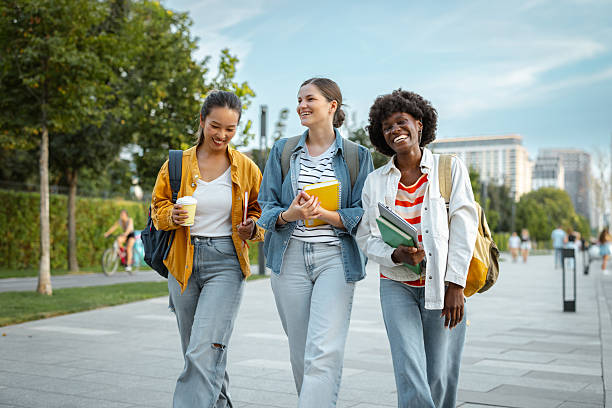 istock Three friends walking outdoors while laughing and enjoying their time together 2230229255