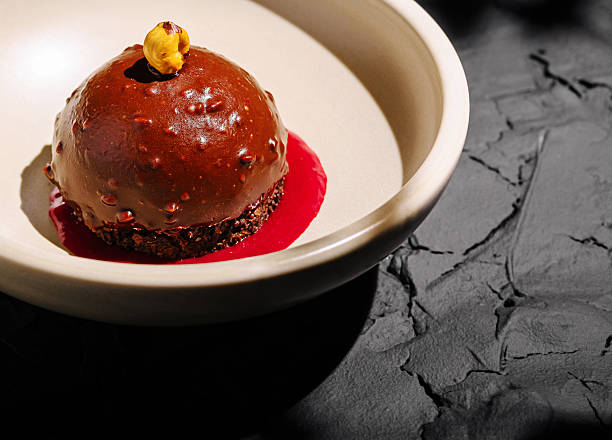 istock Decadent chocolate dessert on a white plate with raspberry sauce 2230229370
