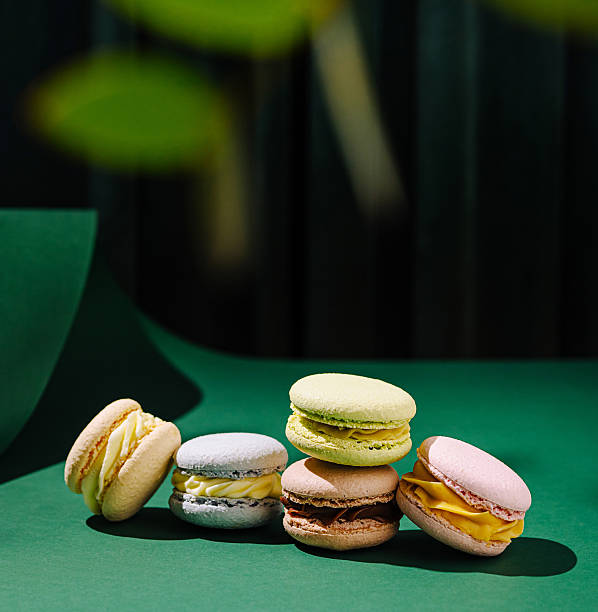 istock Colorful macarons arranged artfully on a green surface in a bright setting 2230230854