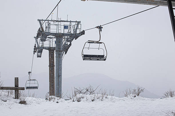 People at ski lift. Ski vacation. Unrecognisable people moving up at ski lift