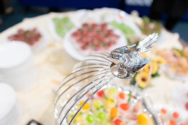 Beautifully decorated catering buffet table with a variety of colorful desserts, pastries, and appetizers served for a party or celebration event. Festive gatherings