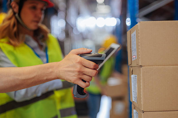 istock Close up of male hand using a barcode scanner on a package 2230231972