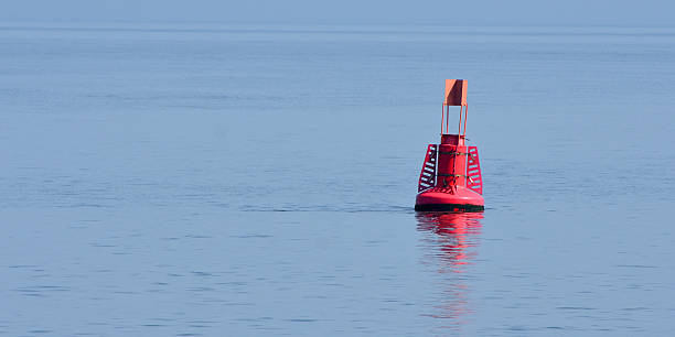 istock Red marker buoy in the sea with reflection 2230235030