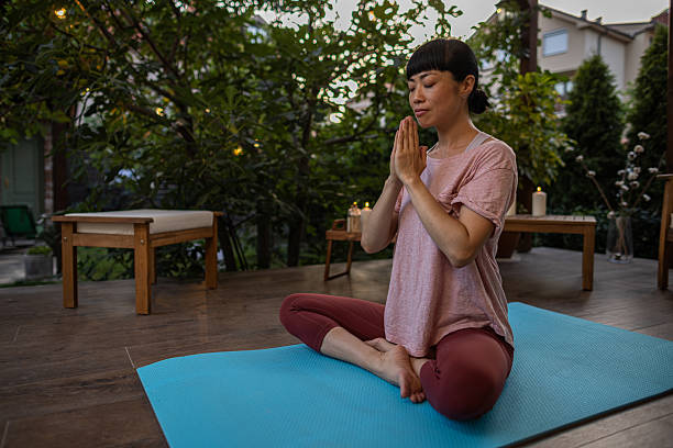 istock Japanese woman meditating on terrace 2230236167