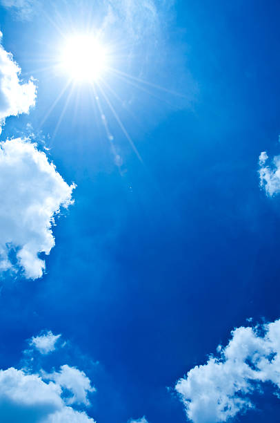 istock Bright Summer Sun and Clear Blue Sky with Fluffy White Clouds 2230236182
