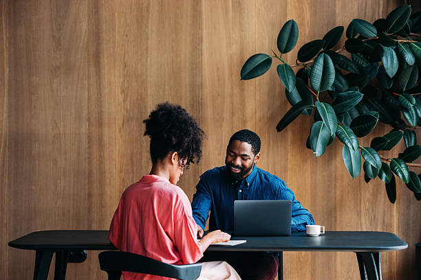 istock Professional Collaboration Between Colleagues in Modern Office Setting with Natural Decor 2230239884