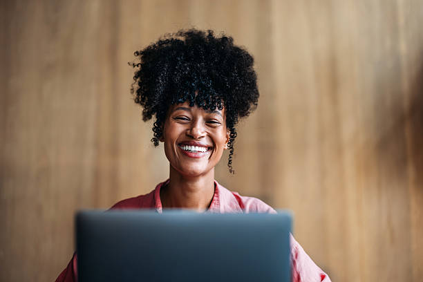 istock Smiling Professional Woman at Desk Using Laptop in Modern Workspace 2230239890