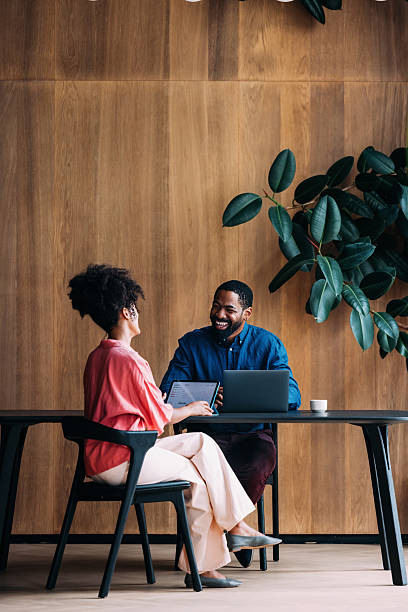 Two Professionals Discussing Business Together in a Modern Office Setting