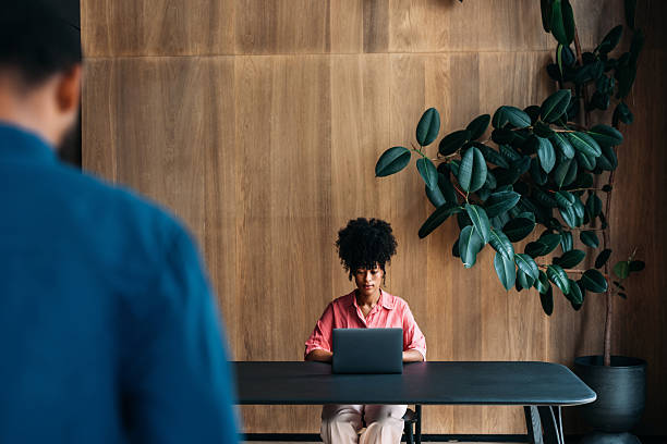 istock Focused Professional Working on Laptop in a Modern Office with Minimalist Design 2230239900