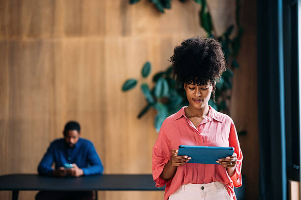Young Professional Female Using Digital Tablet in Modern Office Ambiance