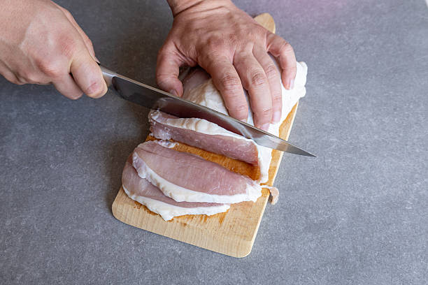 istock Slicing pork loin on cutting board 2230241776