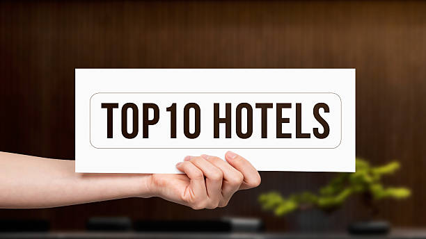 istock Human hand holding a paper on which has been written - TOP 10 hotels 2230244141