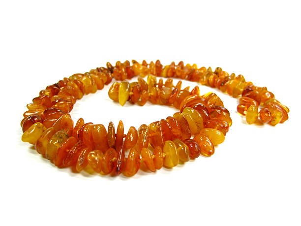 Large amber stone necklace on white background.