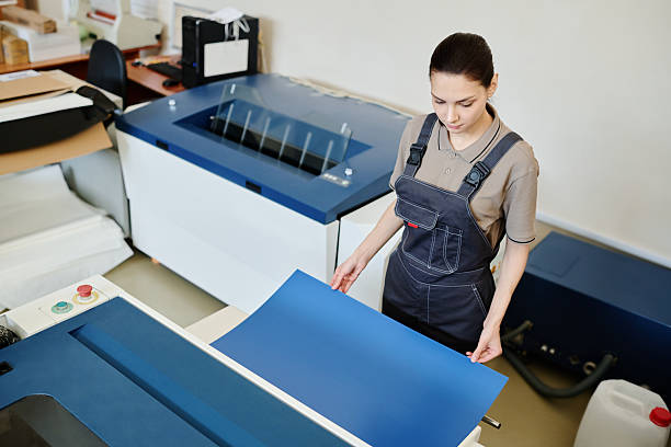 istock Female Print Shop Worker Using Cardstock Paper 2230245358