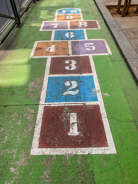 High angle close-up view of a multi colored hopscotch painted in the street in the city of Valencia, Spain