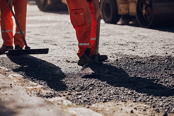 istock Construction workers working on a new asphalt layer on a public street. 2230247089