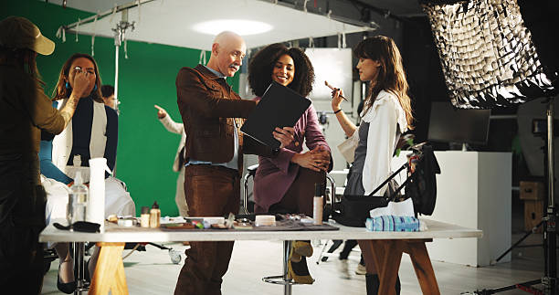 istock People, actress and filming with clipboard in studio for scene notes, feedback and director advice. Team, makeup and prepare with supervisor for movie production, performance guide and script lines 2230248667