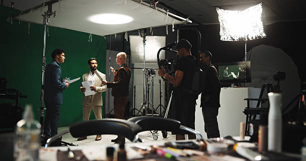 istock People, filming and stabilize with, journalist in studio of broadcast, production process and record. Team, actor lines and cameraman on set for shooting news, documentary footage and scene rehearsal 2230248676