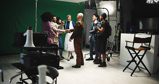 istock Handshake, team and director in studio for creative production, filming and shooting success. Behind the scenes, filmmaking and cast with crew celebrate for good job, well done and thank you on set 2230248691
