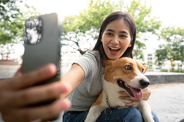 istock Excited woman taking selfie with corgi dog 2230248968