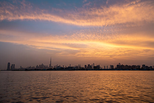 Golden hour panoramic view of Dubai skyline from Creek Harbour waterfront with iconic architecture