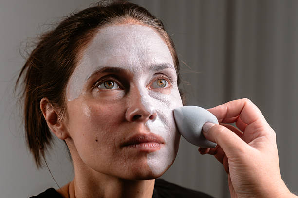 istock Woman's Face Being Prepared with Makeup for Artistic Look 2230249502
