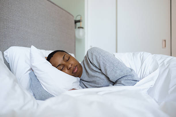 istock Serene woman sleeping soundly in comfortable bed 2230251582