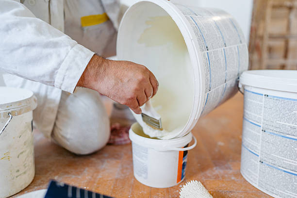 istock Mature Worker Mixing The Paint In An Empty Apartment Under Renovation 2230251728