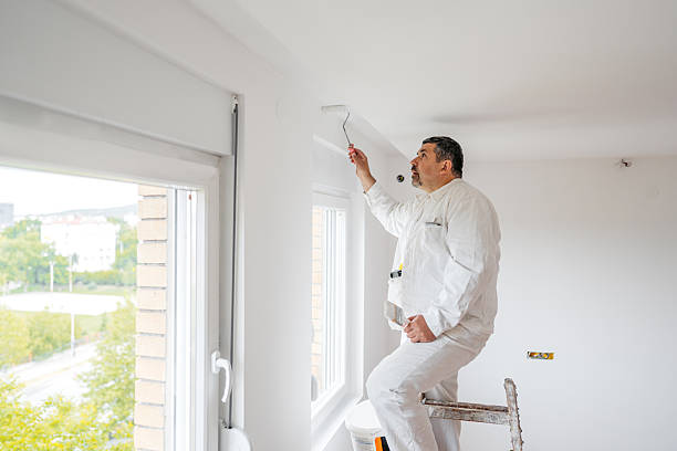 istock Mature Worker Painting The Ceiling With A Paint Roller In An Empty Apartment Under Renovation 2230251801