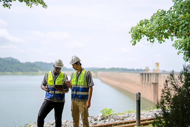 istock An environmentalist and engineer are co-working at the dam. 2230252692