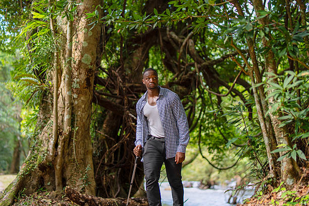 A man is hiking in the forest while in vacation. Leisure activity and nature concept.