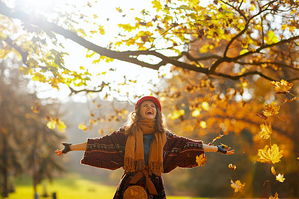 istock smiling modern woman in red hat with scarf rejoicing 2230257355