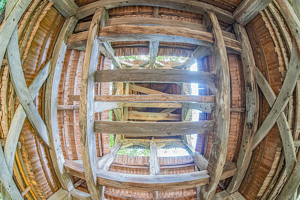 istock Exposed wooden beams, ancient Central European village interior, circular ceiling pattern, large skylight, natural light, warm tone, rustic wood texture, daytime shadows, realistic photography style 2230259316